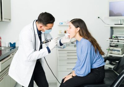 doctor checking patient for throat infection