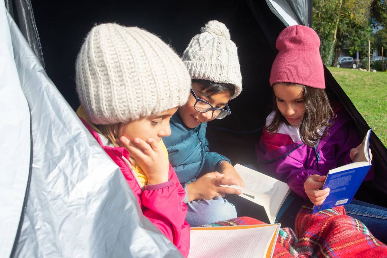 Kids reading books in Tent